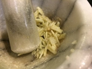 Salt and mash garlic